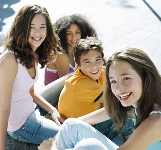Group of four teens smiling